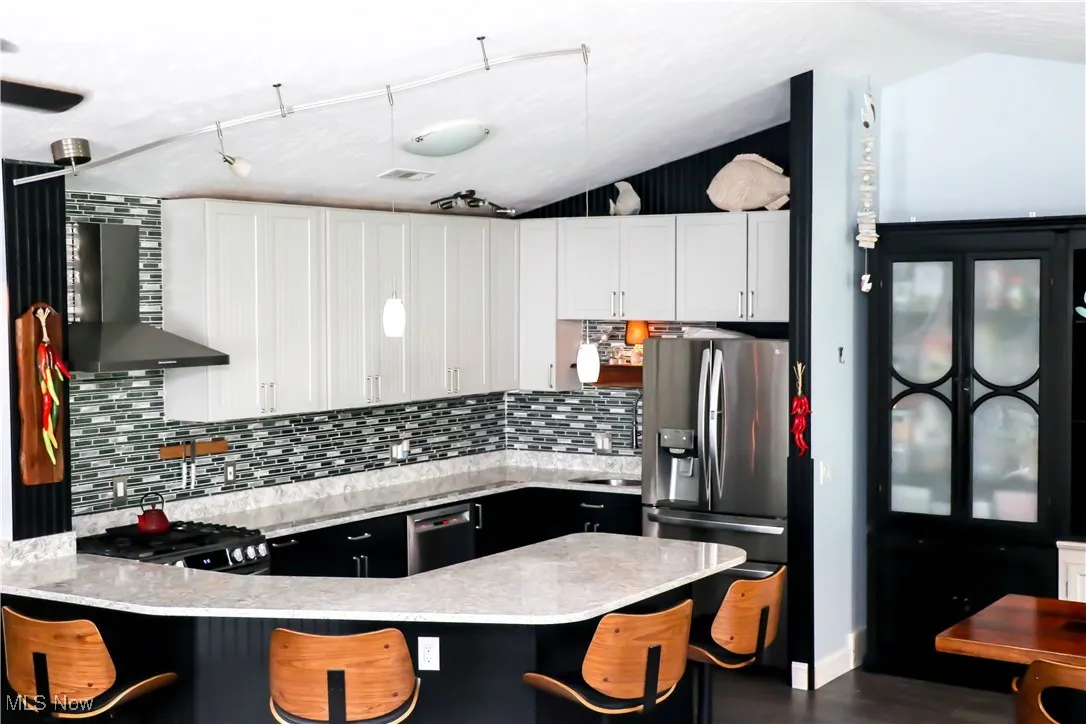 Custom, gorgeous kitchen with Cambria countertops, stainless steel hood, stunning backsplash & custom cabinetry!