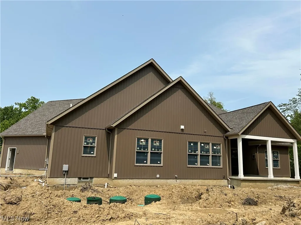 Rear view of house with a shingled roof