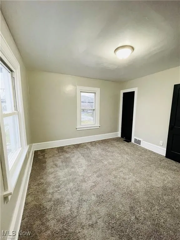 Unfurnished bedroom with carpet and baseboards