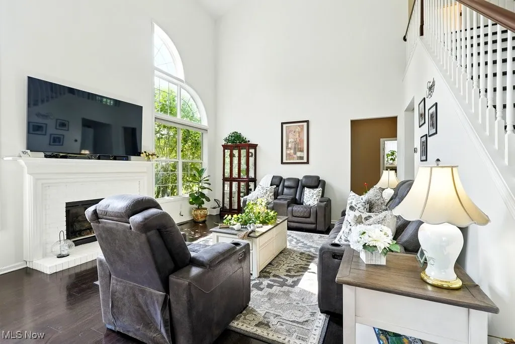 Great Room with Fireplace, Window Treatment, Gorgeous Large Window that Flanks Both Sides of Fireplace, and Two Story Ceiling Height