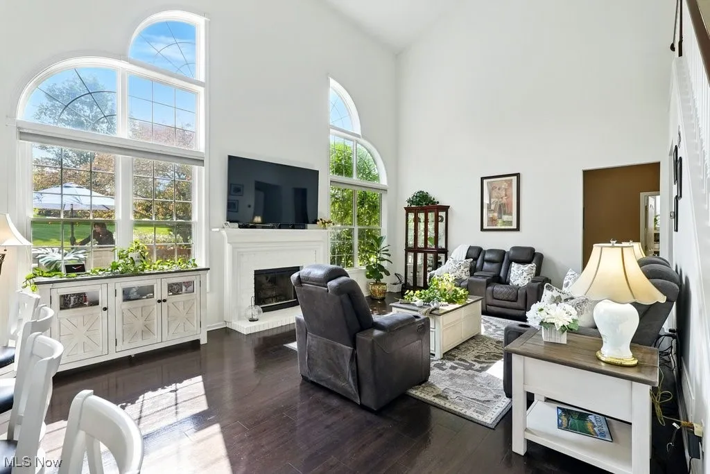 Great Room with Fireplace, Window Treatment, Gorgeous Large Window that Flanks Both Sides of Fireplace, and Two Story Ceiling Height