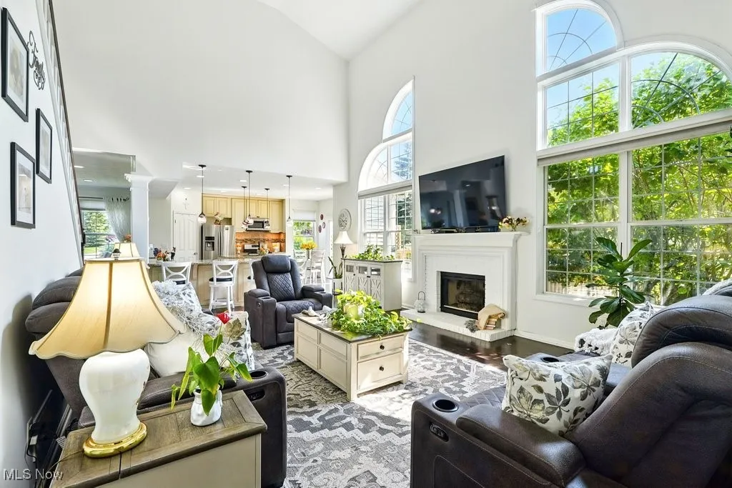 Great Room with Fireplace, Window Treatment, Gorgeous Large Window that Flanks Both Sides of Fireplace, and Two Story Ceiling Height