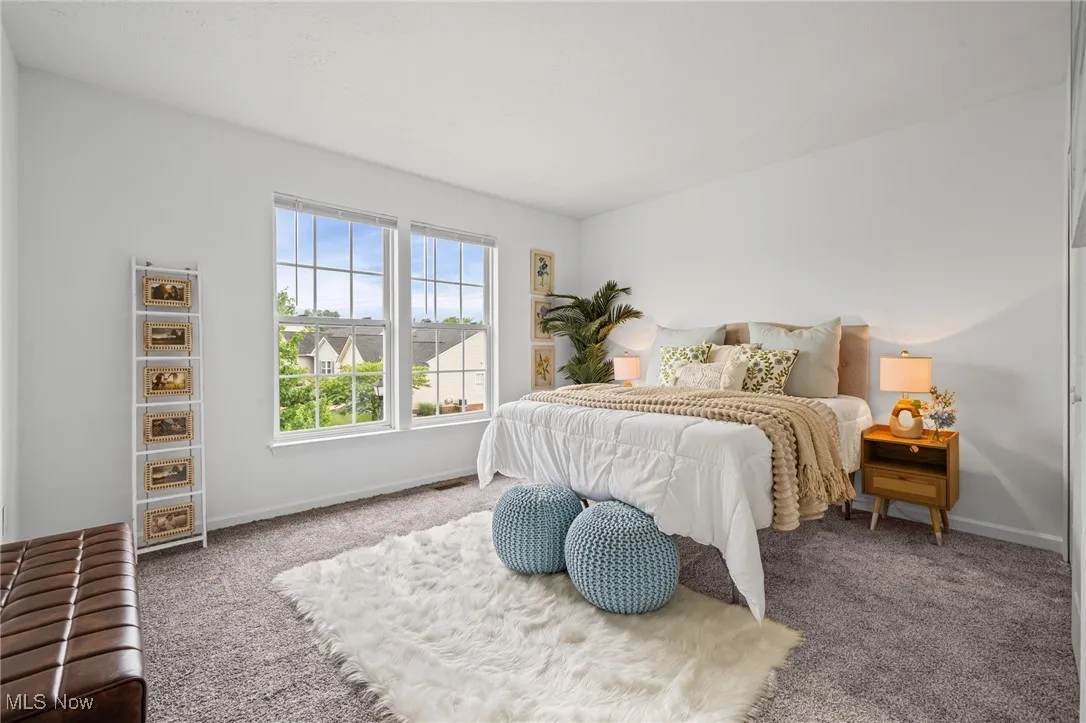 Bedroom featuring carpet and baseboards