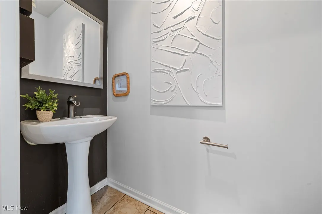 Bathroom with baseboards and tile patterned flooring