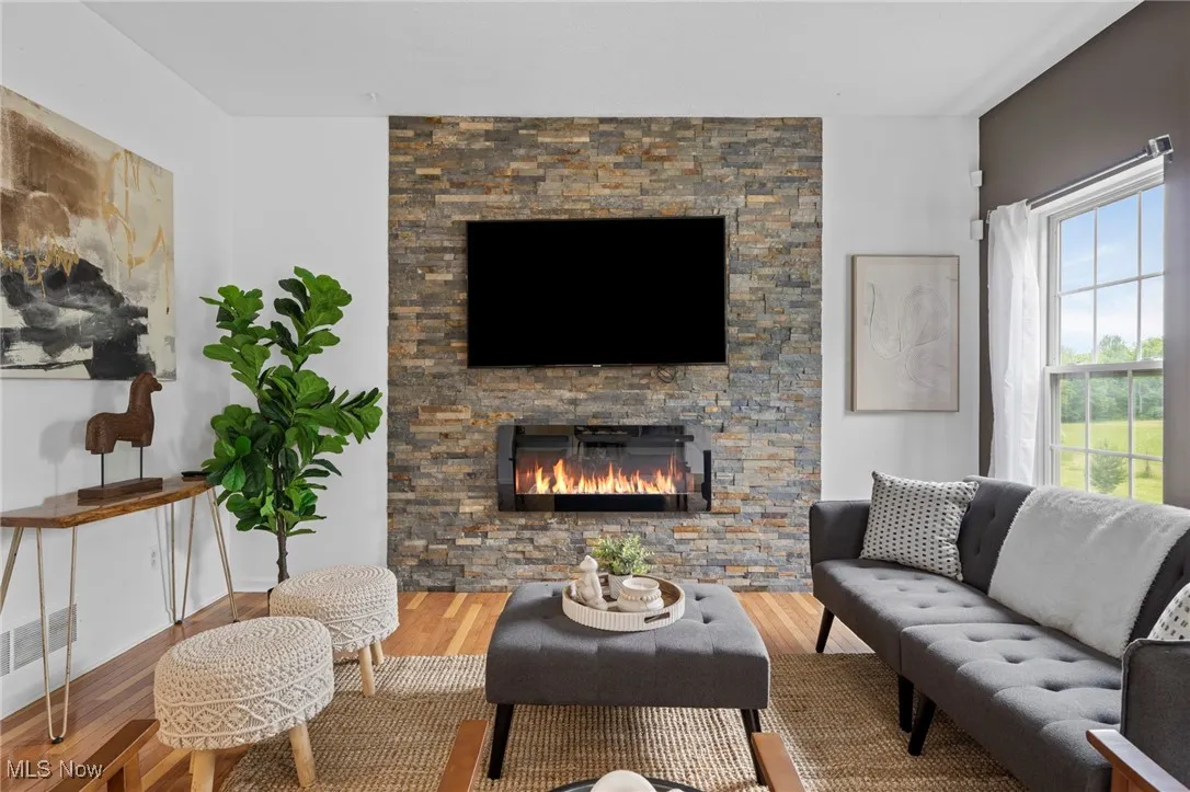 Living area with wood finished floors and a fireplace