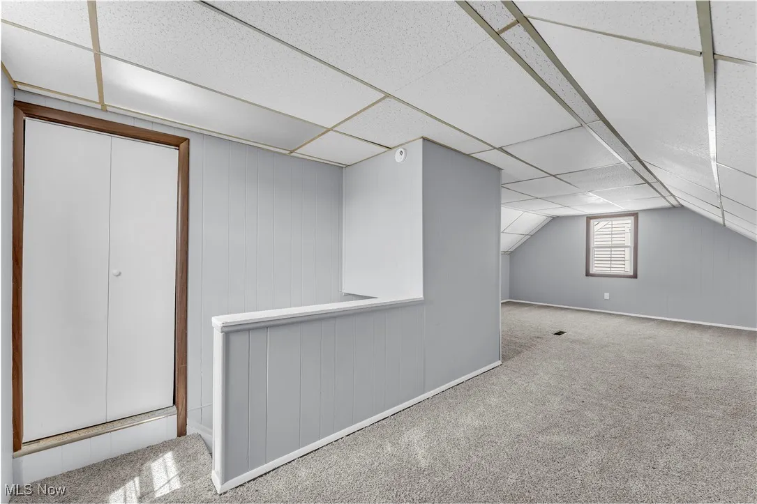 Bonus room featuring carpet floors and vaulted ceiling