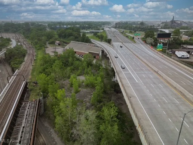 Drone / aerial view of a main thoroughfare and a tree filled landscape