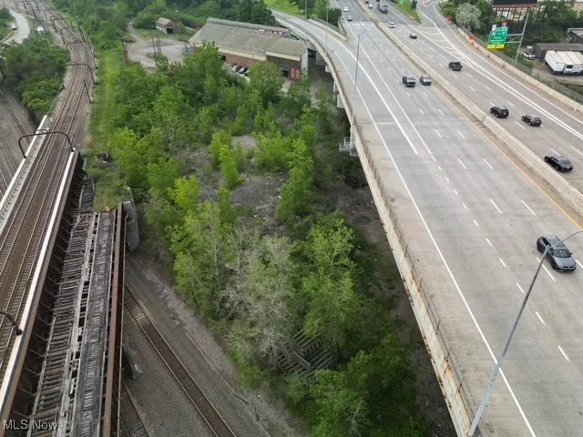 Drone / aerial view of a highway and a tree filled landscape