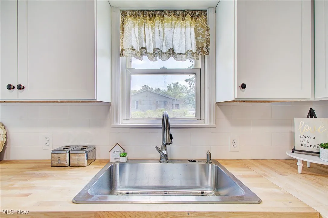 New stainless sink and always timeless subway tile backsplash.