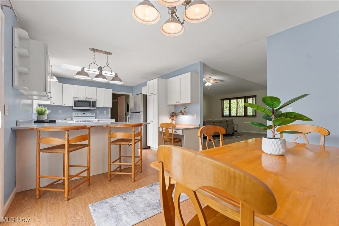 Dining area with light wood-style flooring and a chandelier