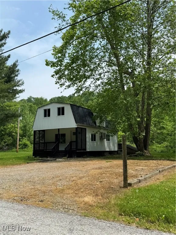 Dutch colonial featuring a gambrel roof and metal roof