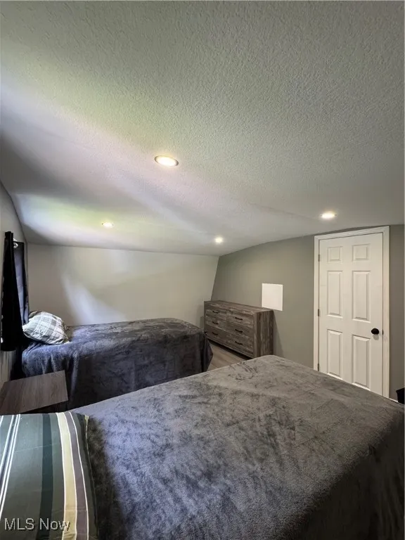 Bedroom featuring recessed lighting and a textured ceiling