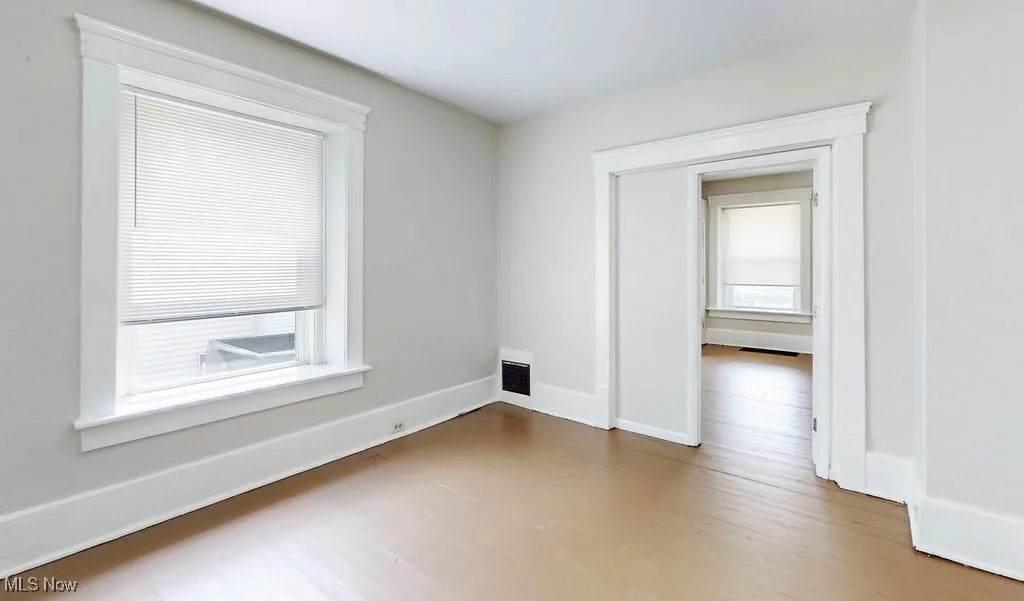 Livingroom with wood finished floors, healthy amount of natural light, and baseboards