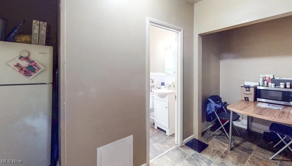 Kitchen/dining area and view of the bathroom