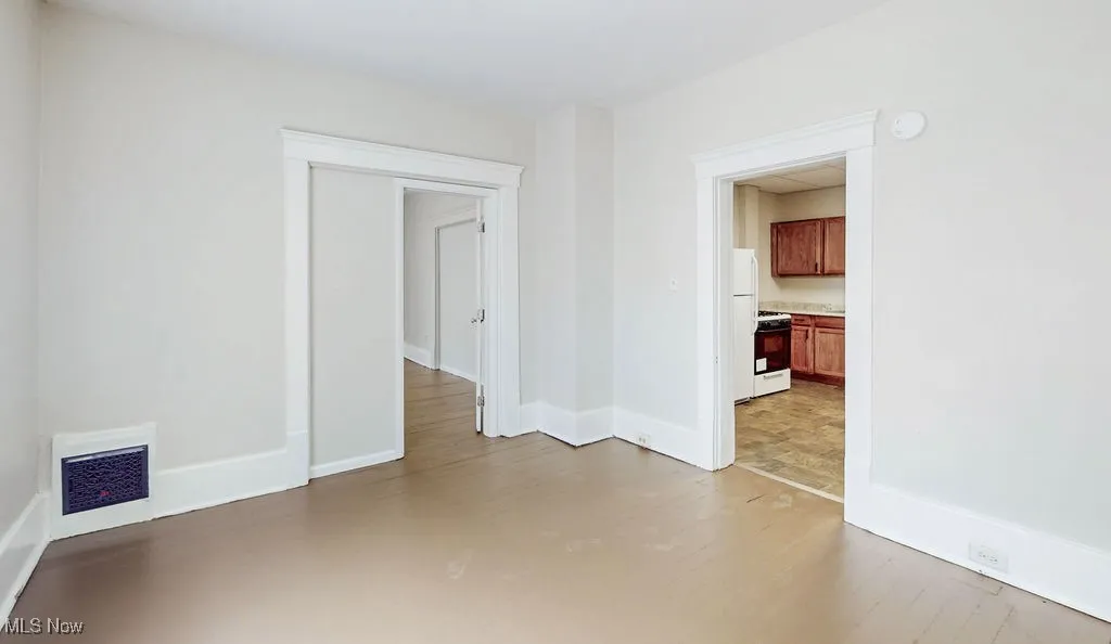Livingroom with baseboards, wood finished floors, and a smoke detector