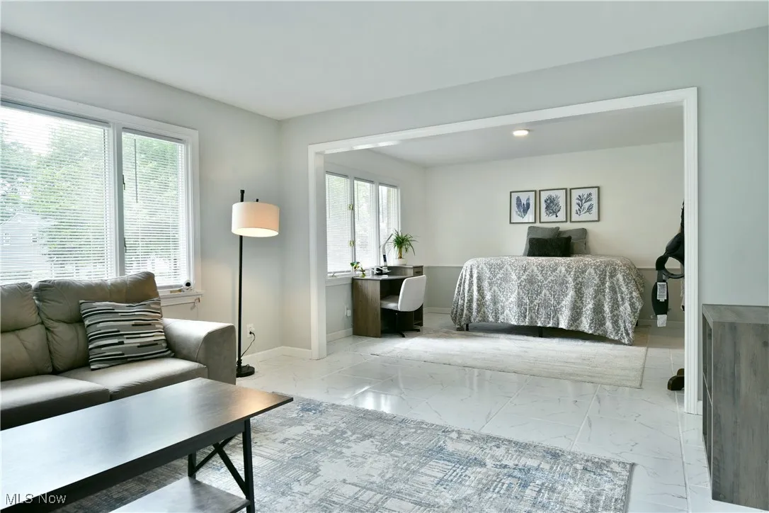 Living room with marble finish flooring and baseboards