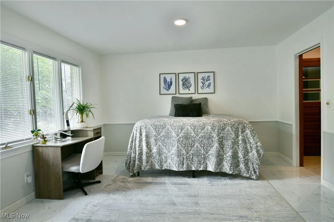 Home office featuring marble finish flooring, baseboards, and recessed lighting