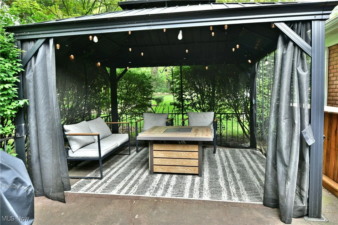 View of patio with a gazebo and outdoor lounge area