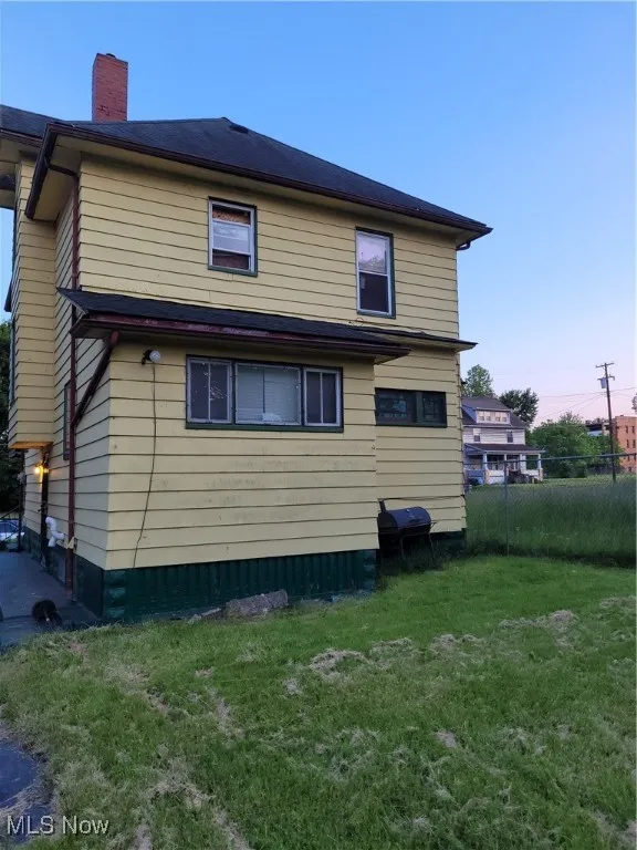 Back of property with a chimney