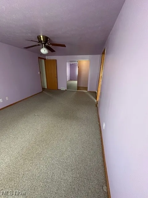 Master Bdr with ceiling fan, baseboards, and carpet