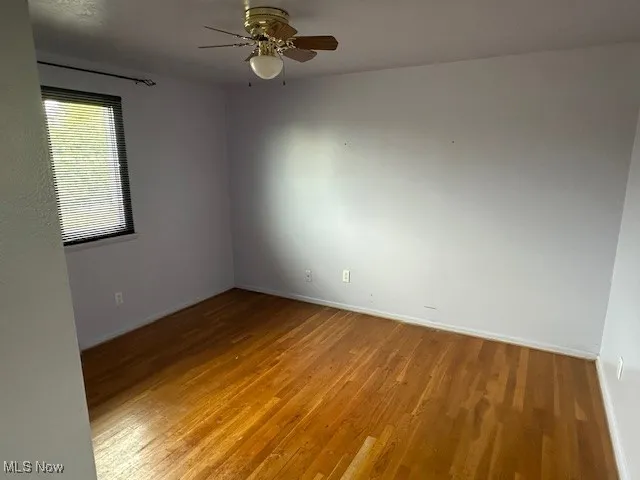 Bdr 2with light wood-style flooring, baseboards, and ceiling fan