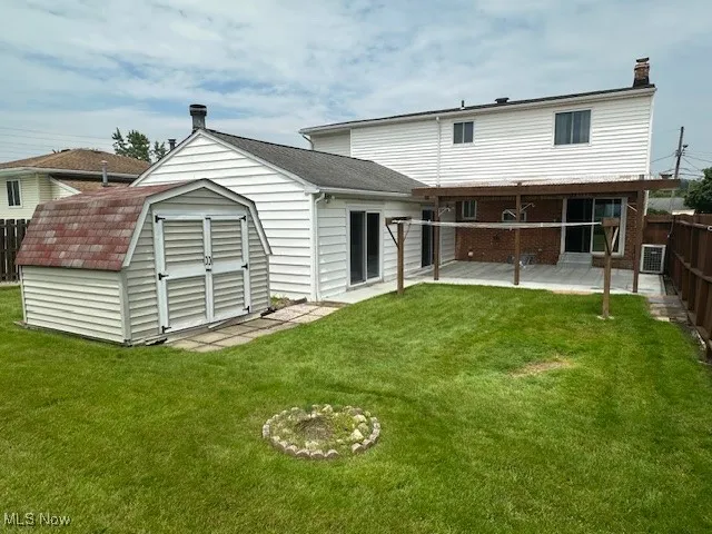 Back of property featuring a patio, central AC, and a chimney