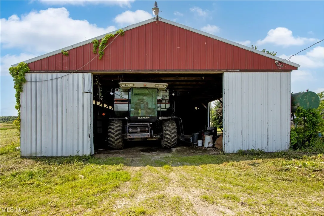 View of pole building with a yard and cooling unit