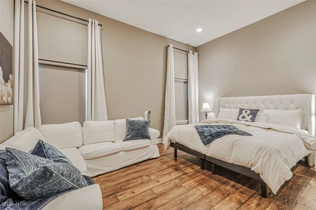 Bedroom with wood-type flooring and recessed lighting