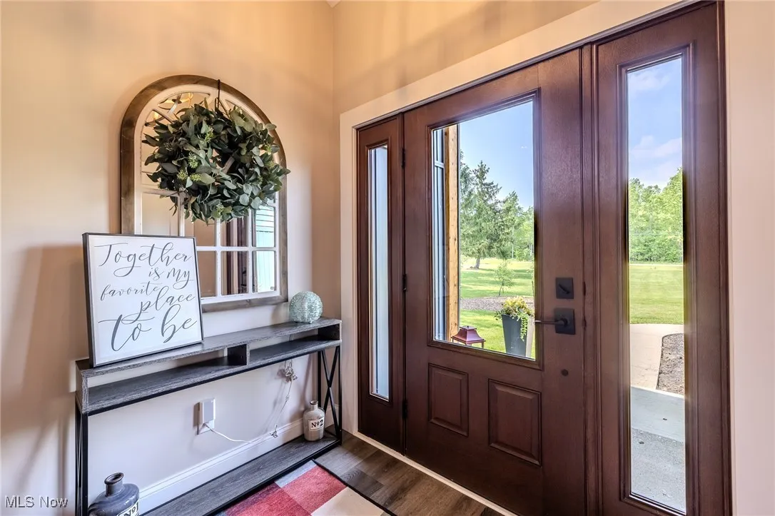 Entrance foyer featuring dark wood-type flooring