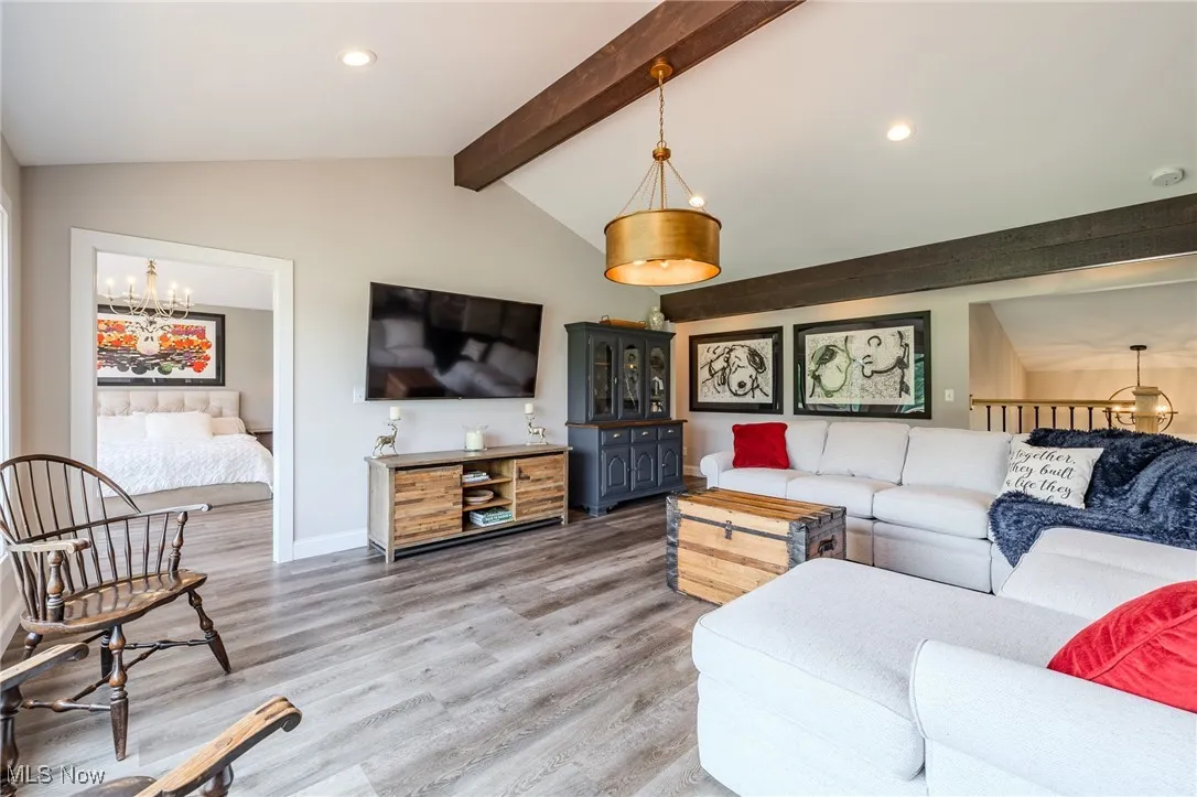 Living area with a chandelier, light wood-style floors, recessed lighting, and baseboards