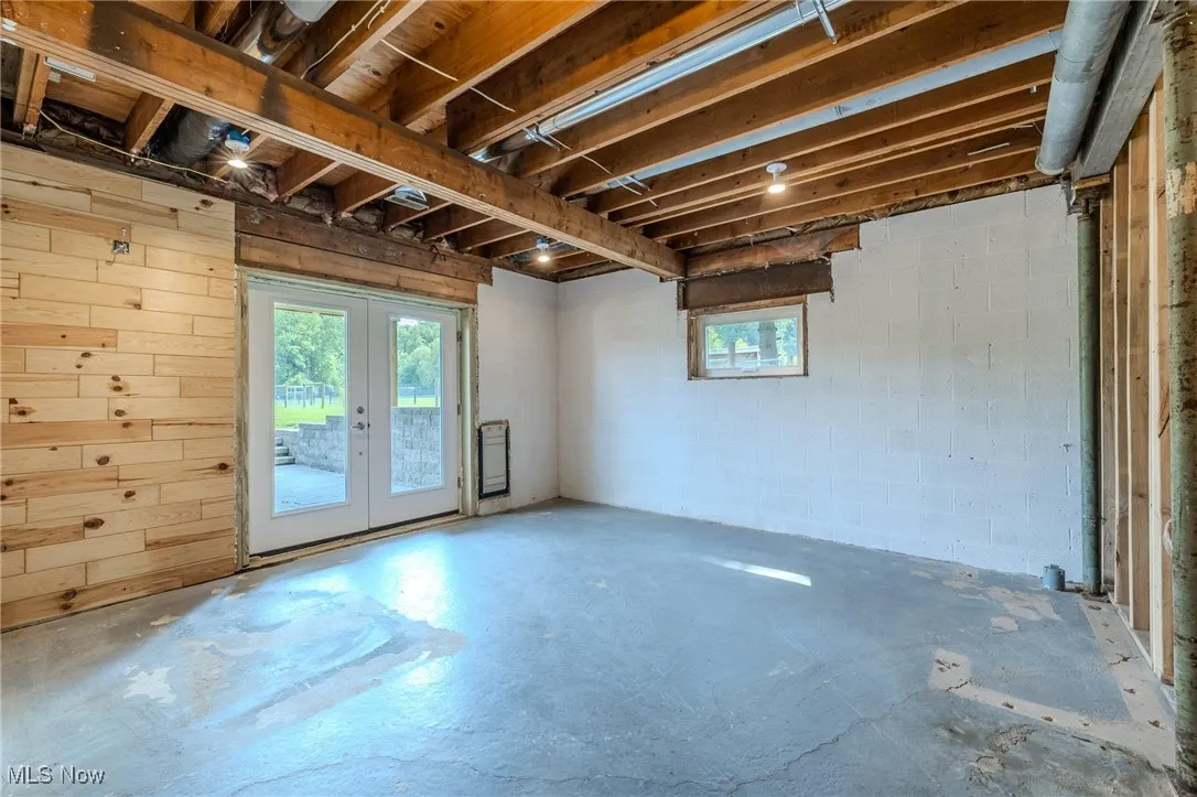Basement featuring plenty of natural light and french doors