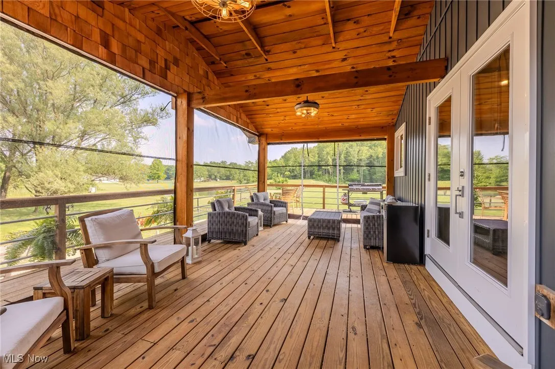 Sunroom / solarium with french doors and an outdoor hangout area