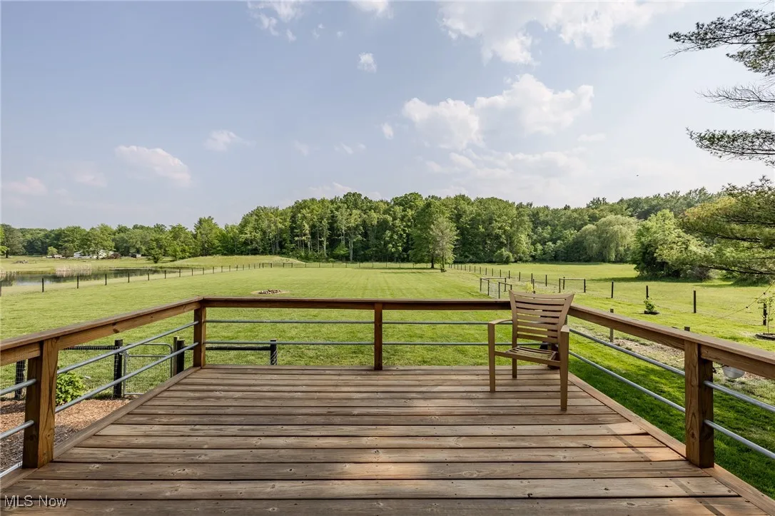Deck with a rural view and a lawn