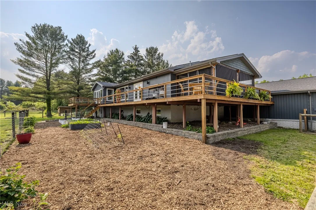 Back of house featuring a wooden deck