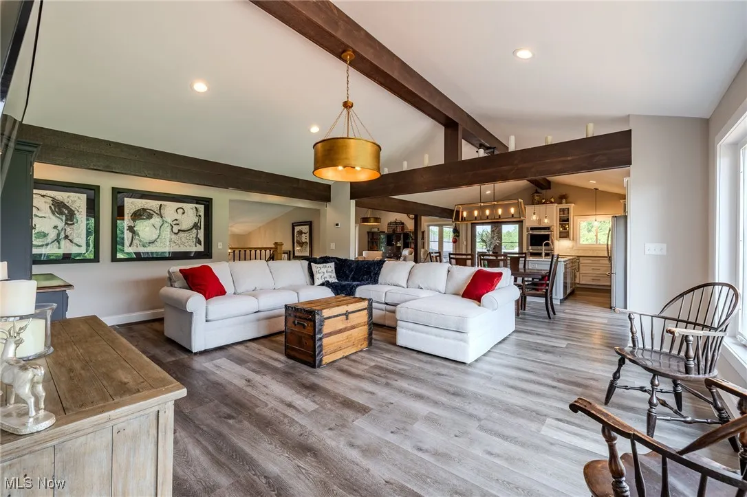 Living area featuring wood finished floors, recessed lighting, and baseboards