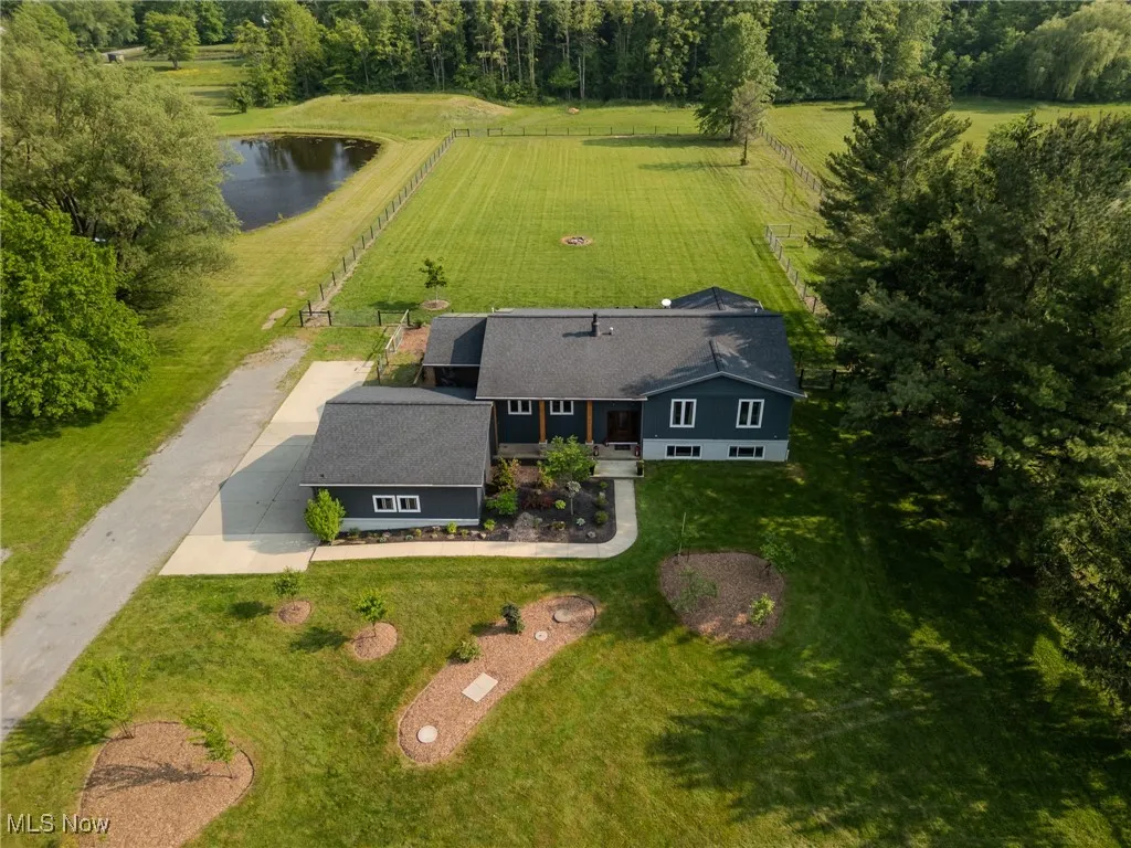 Aerial view of property and surrounding area featuring a nearby body of water