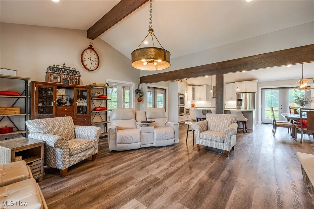 Living area with dark wood finished floors and recessed lighting