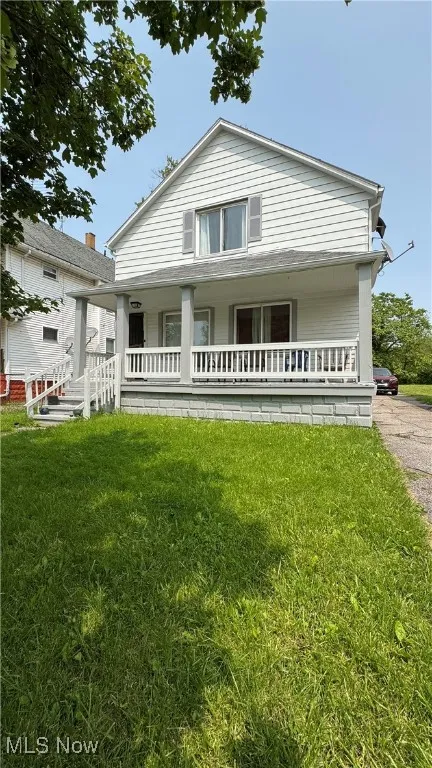 Bungalow-style home featuring covered porch and a front lawn