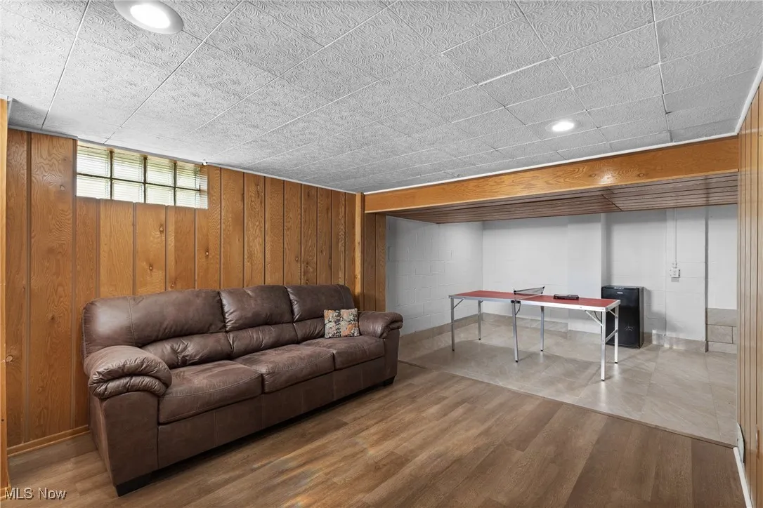 Living room with wood finished floors and wood walls