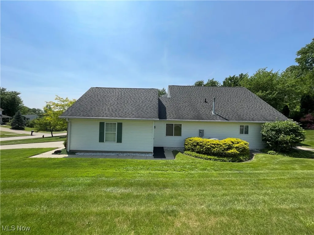 The side view of property showing from your neighbor's yard gives you plenty of space from your neighbor and hides your newer looking Carrier air conditioner.