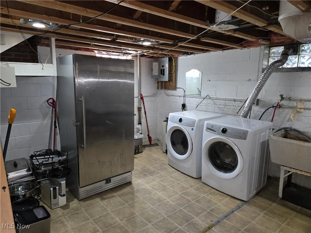 Washroom featuring washer and dryer and electric panel