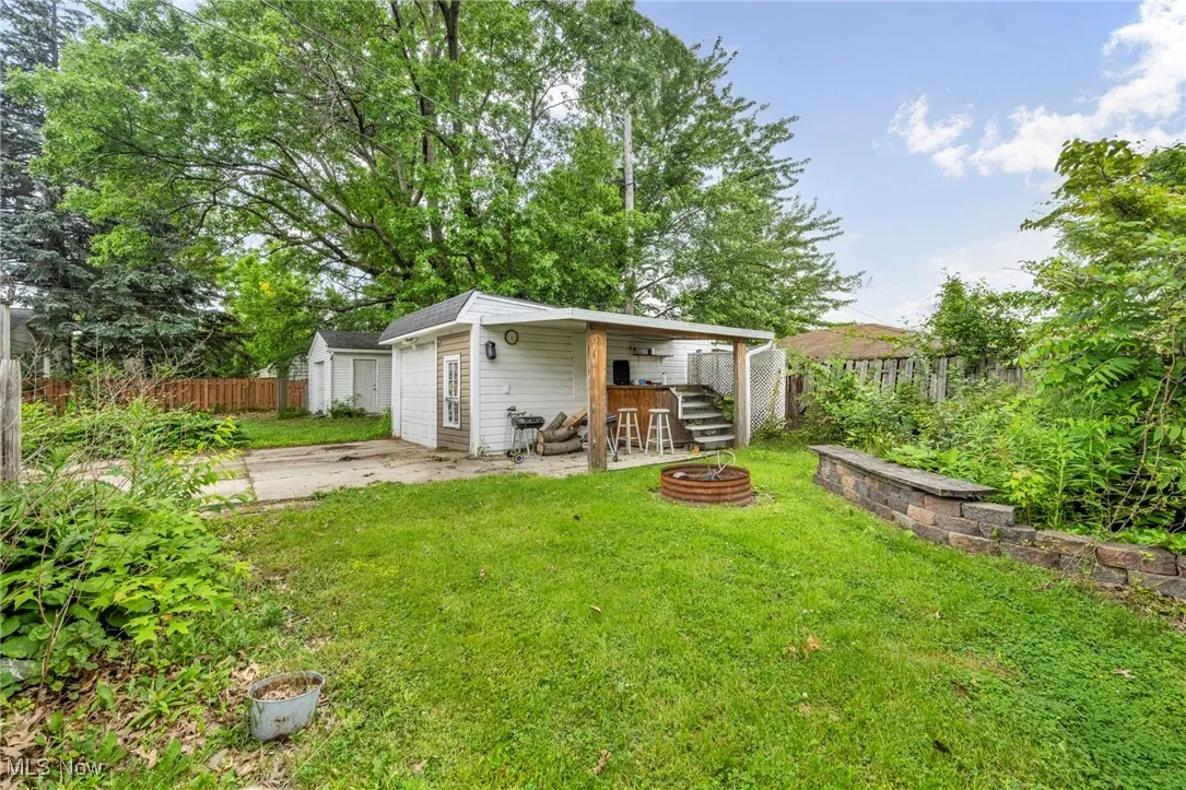 Back of house with an outdoor fire pit