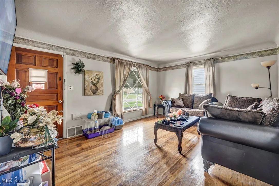 Living room featuring a textured ceiling and wood finished floors