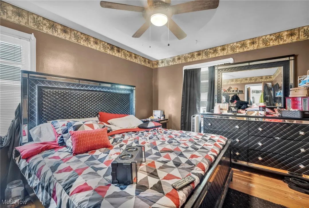 Bedroom featuring wood finished floors and a ceiling fan