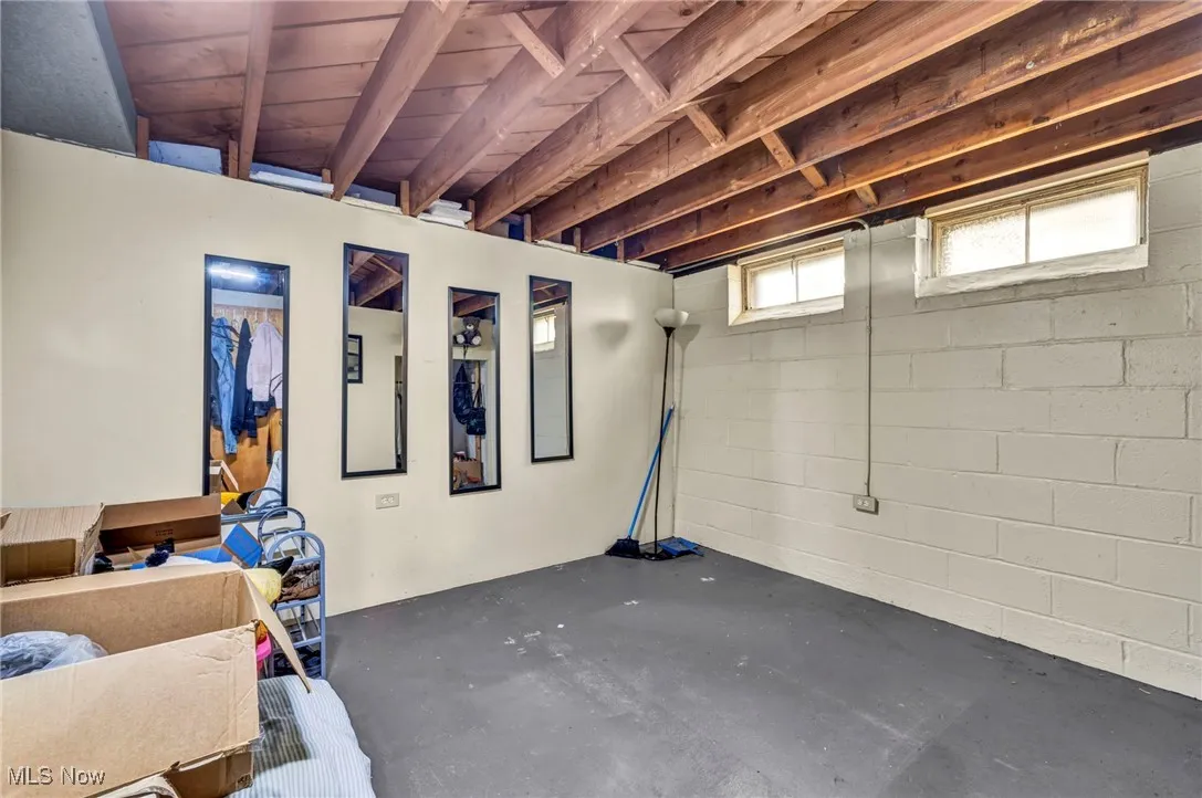 Below grade area featuring concrete block wall