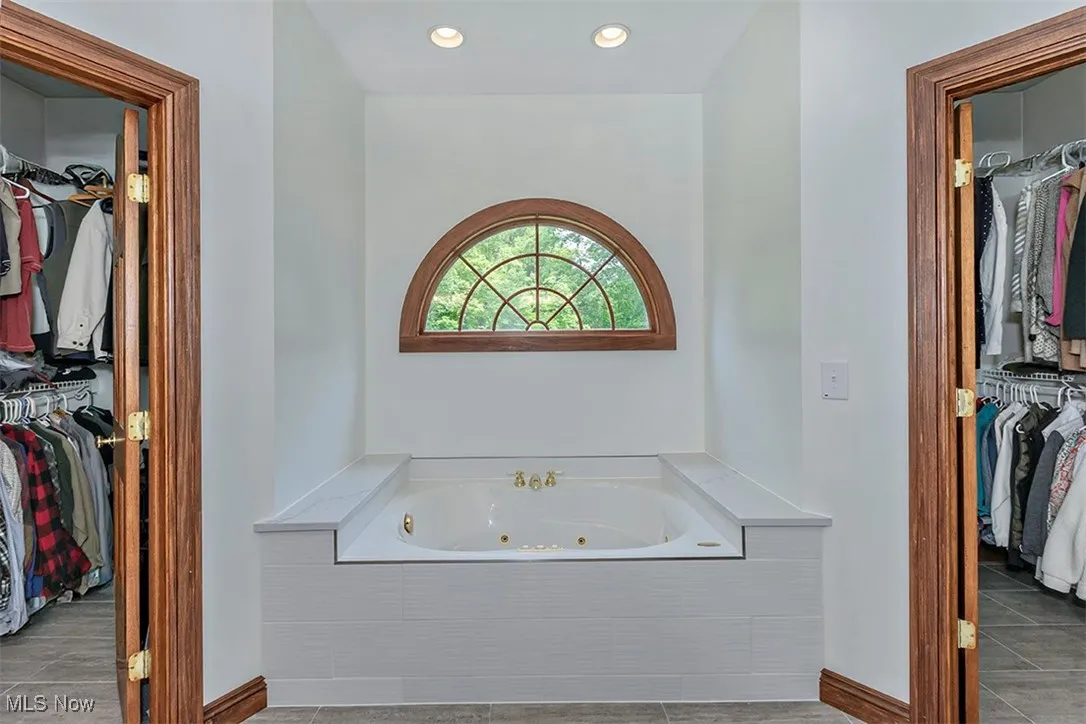 Master bath soaking/jetted tub with dual his and hers walkin closets.