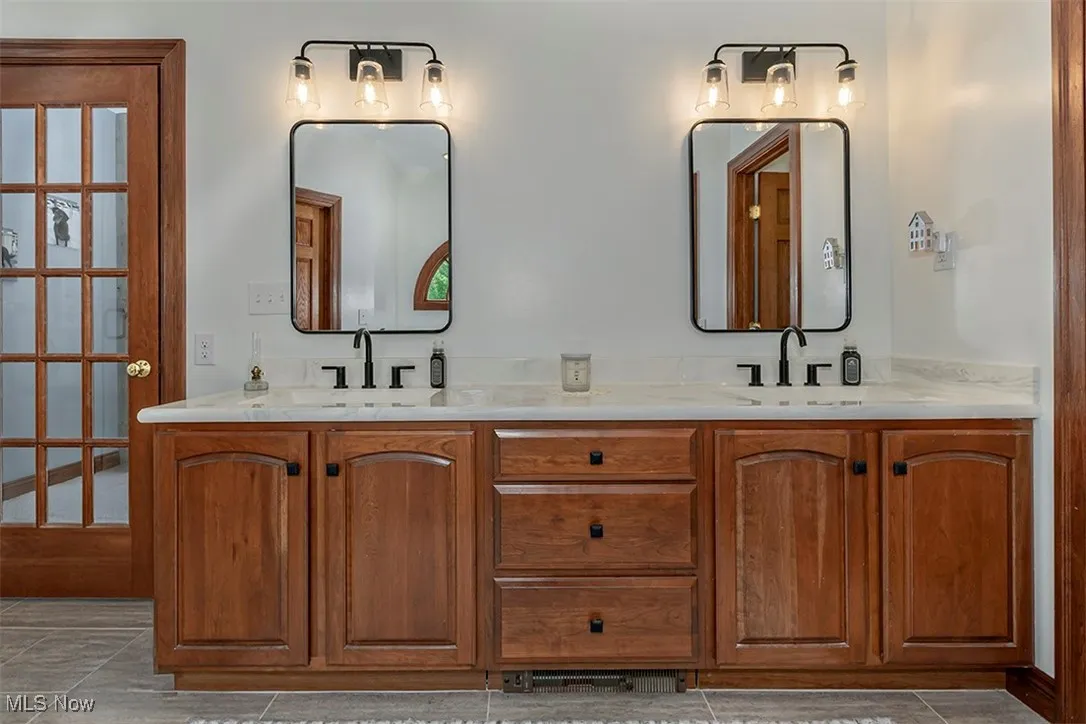 Dual vanity.  The glass door on the left leads into the master bedroom