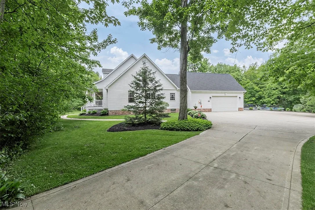 Concrete drive is long enough to ensure your privacy. Side load garage.  This home is engulfed in verdant serenity.
