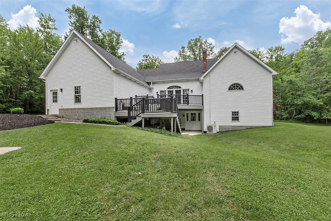 This view shows the 2 tiered deck and walkout basement.