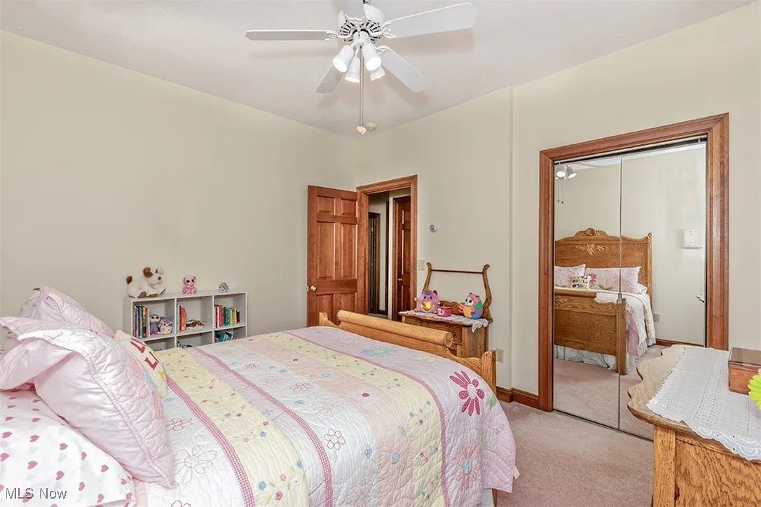 Second bedroom. Mirrored closet and ceiling fan.